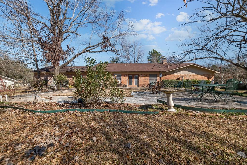 703 Amy Street Canton, TX 75103 - Photo 2 of 32 a backyard of a house with table and chairs