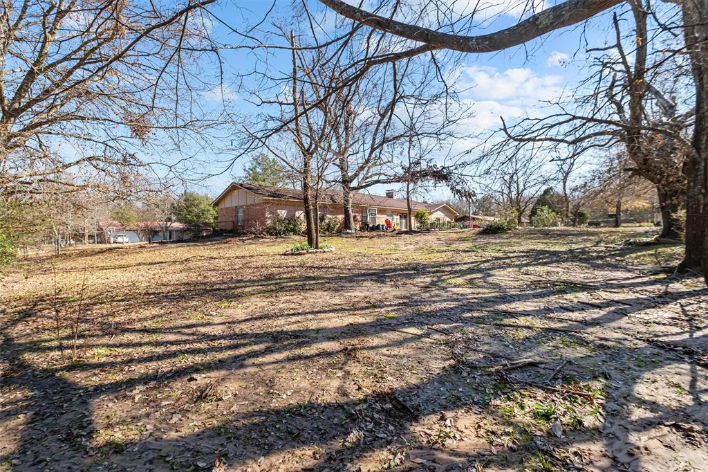 703 Amy Street Canton, TX 75103 - Photo 3 of 32 a view of a yard with a trees