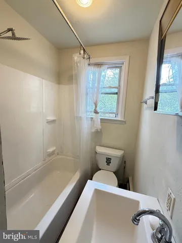 a bathroom with a tub and a shower