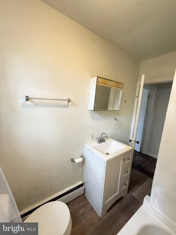a bathroom with a sink mirror vanity and toilet