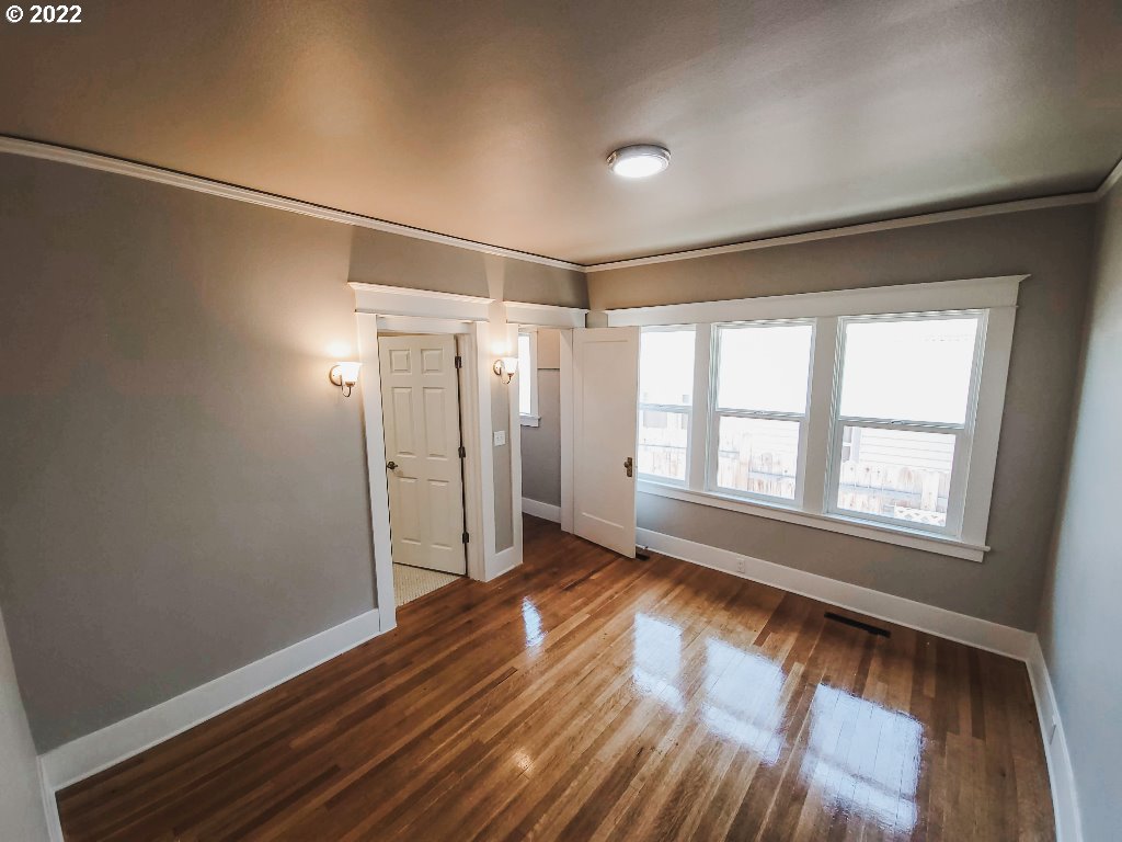 324 Northwest 9th Street Pendleton, OR 97801 - Photo 13 of 24 an empty room with wooden floor and windows