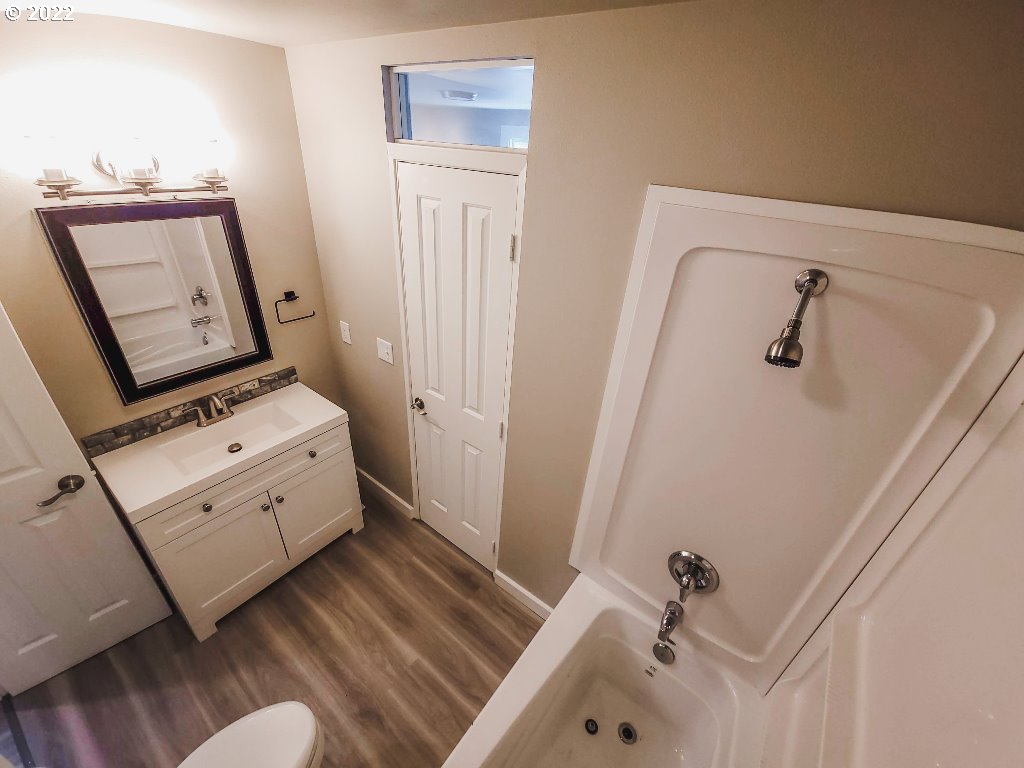 324 Northwest 9th Street Pendleton, OR 97801 - Photo 18 of 24 a bathroom with a window toilet and sink