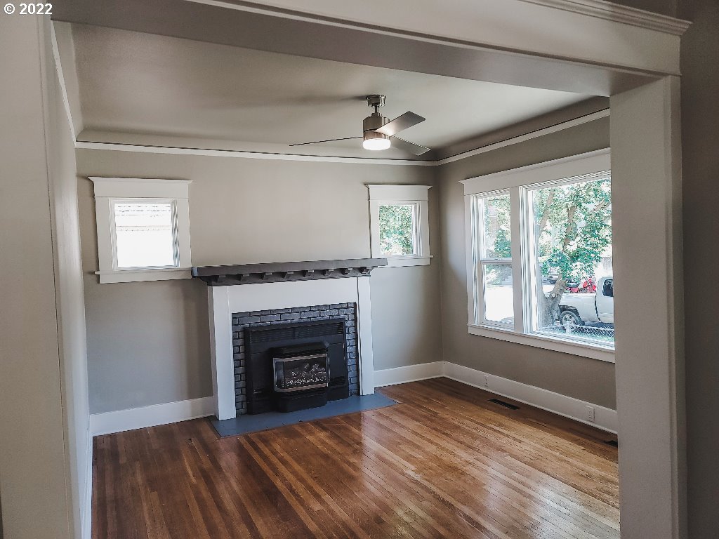 324 Northwest 9th Street Pendleton, OR 97801 - Photo 24 of 24 a view of an empty room with wooden floor fireplace and a window