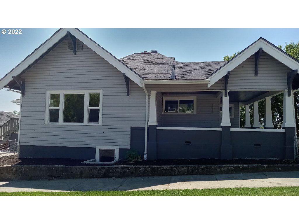 324 Northwest 9th Street Pendleton, OR 97801 - Photo 5 of 24 a view of a house with a small yard and wooden fence