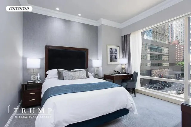 a bedroom with a large bed and a large window