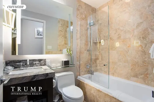 a view of a bedroom with a bed and glass door