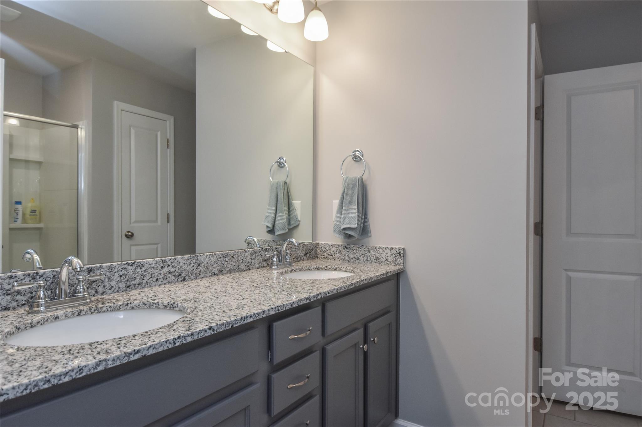 8097 Sheffield Dr. Drive Terrell, NC 28682 - Photo 13 of 26 a bathroom with a granite countertop sink and a mirror