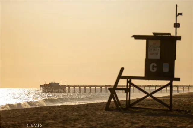 a bedroom with a bed and large windows