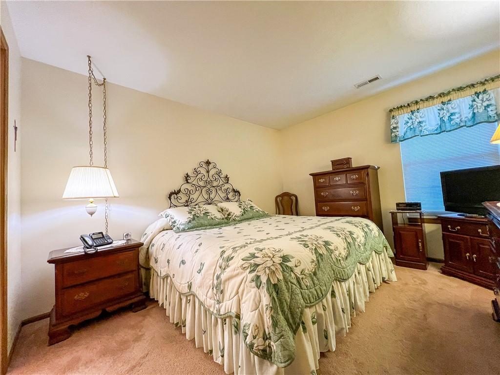 104 Brookstone Court Butler, PA 16001 - Photo 12 of 34 a spacious bedroom with two bed and a flat tv screen on the dresser