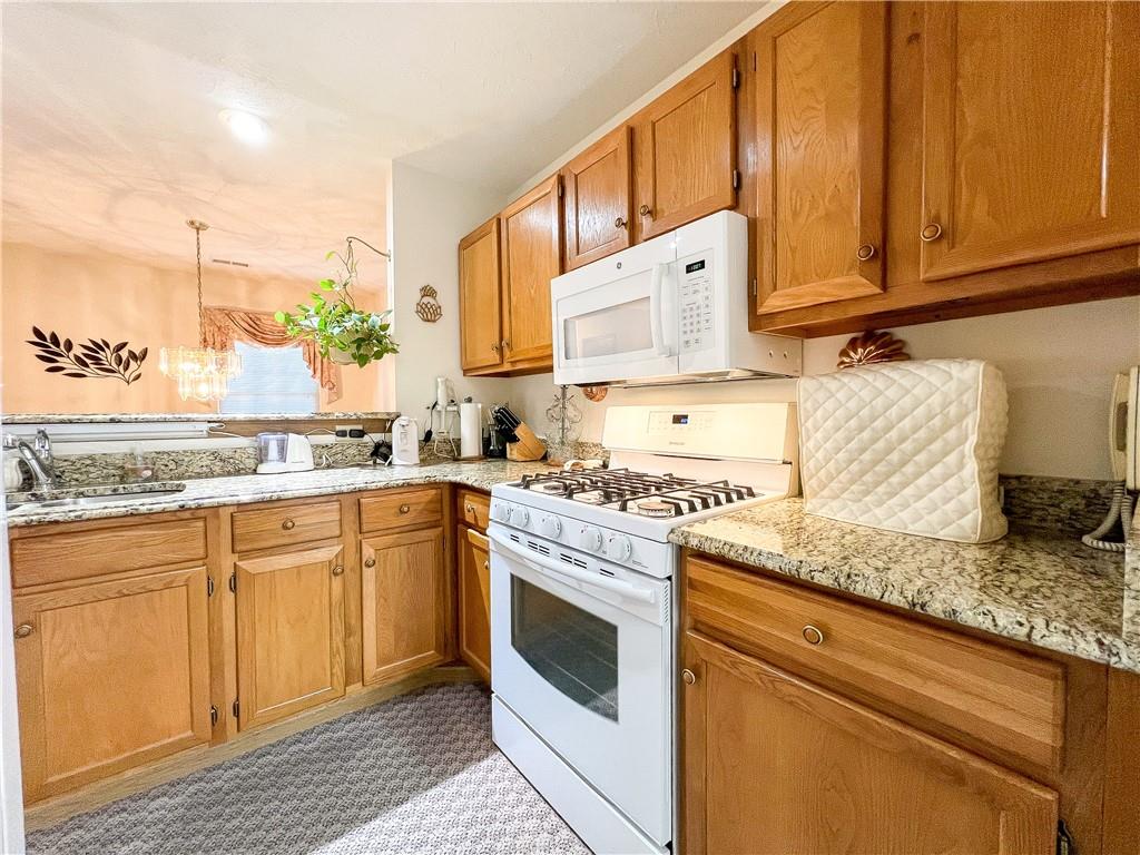 104 Brookstone Court Butler, PA 16001 - Photo 5 of 34 a kitchen with granite countertop a sink stove and cabinets