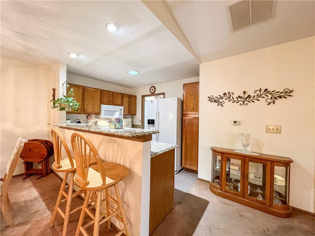 104 Brookstone Court Butler, PA 16001 - Photo 6 of 34 a living room with stainless steel appliances kitchen island granite countertop furniture and a wooden floor