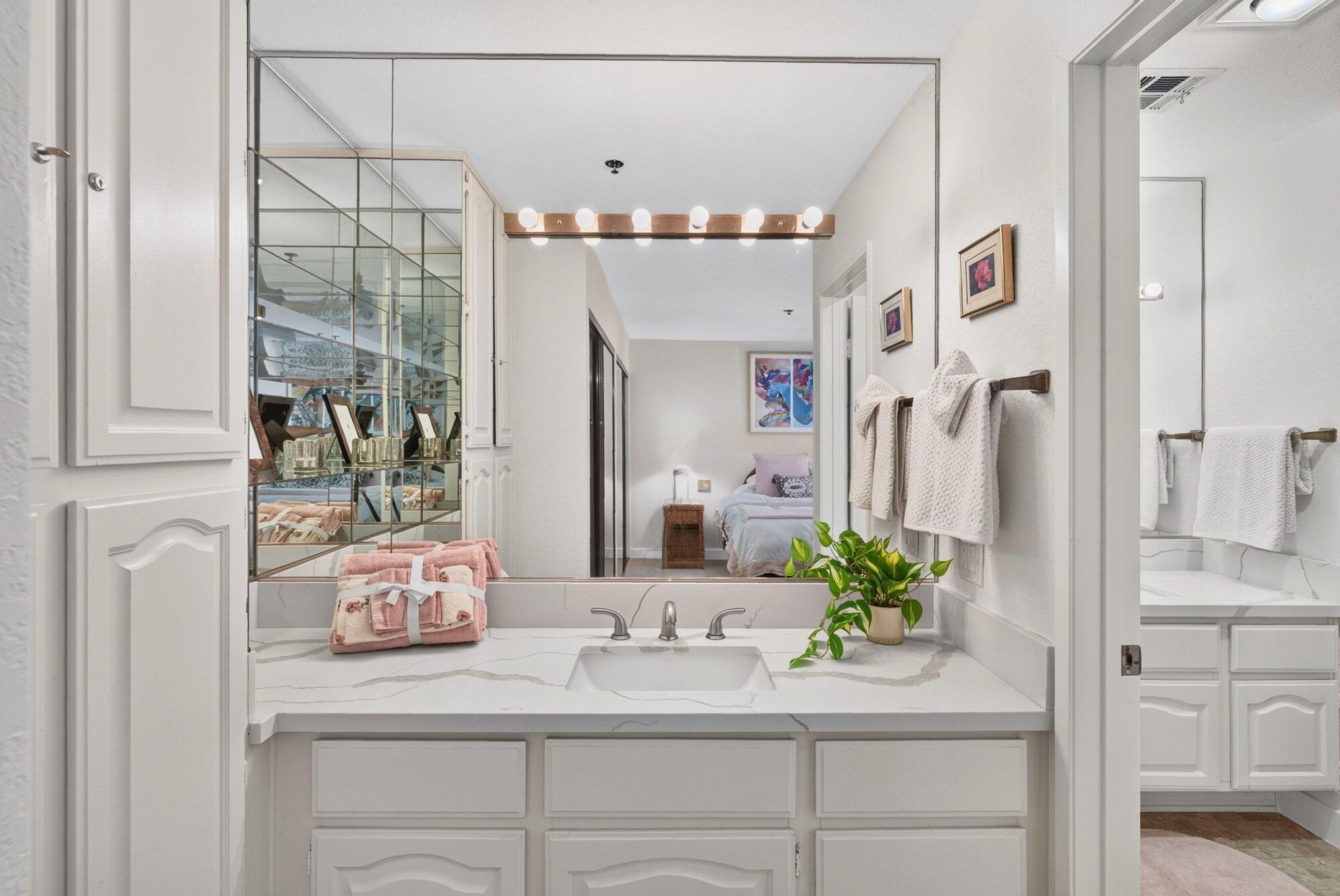 500 East Amado Road, Unit 313 Palm Springs, CA 92262 - Photo 13 of 32 a bathroom with a sink and a mirror