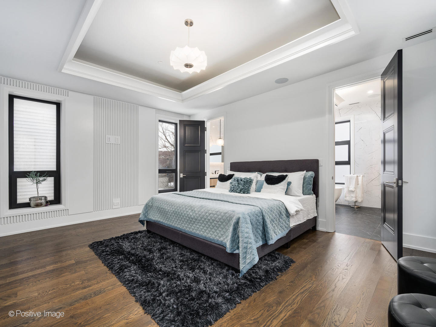 1216 West George Street Chicago, IL 60657 - Photo 15 of 42 a spacious bedroom with a bed and a dresser with wooden floor