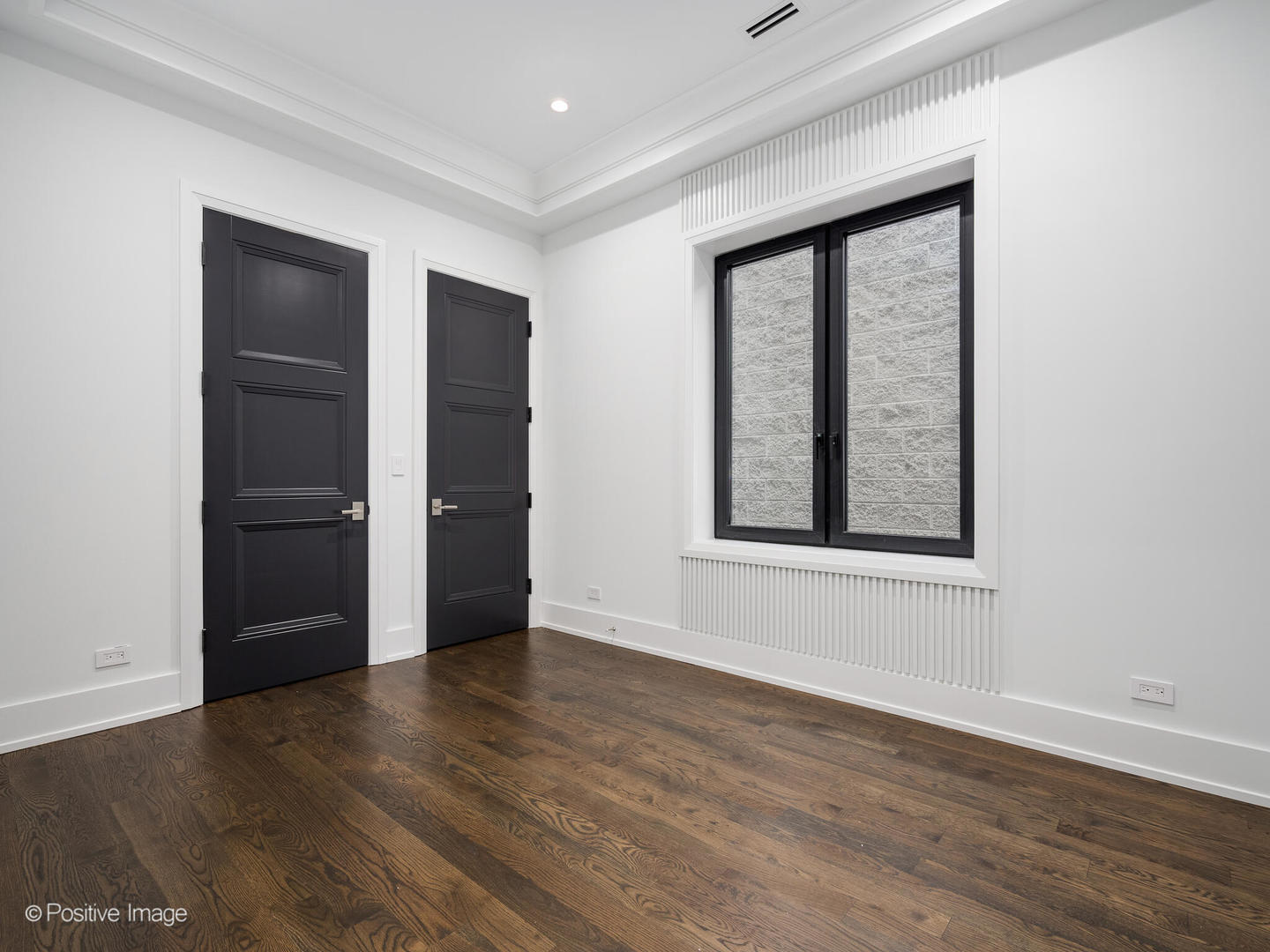 1216 West George Street Chicago, IL 60657 - Photo 21 of 42 an empty room with wooden floor and windows