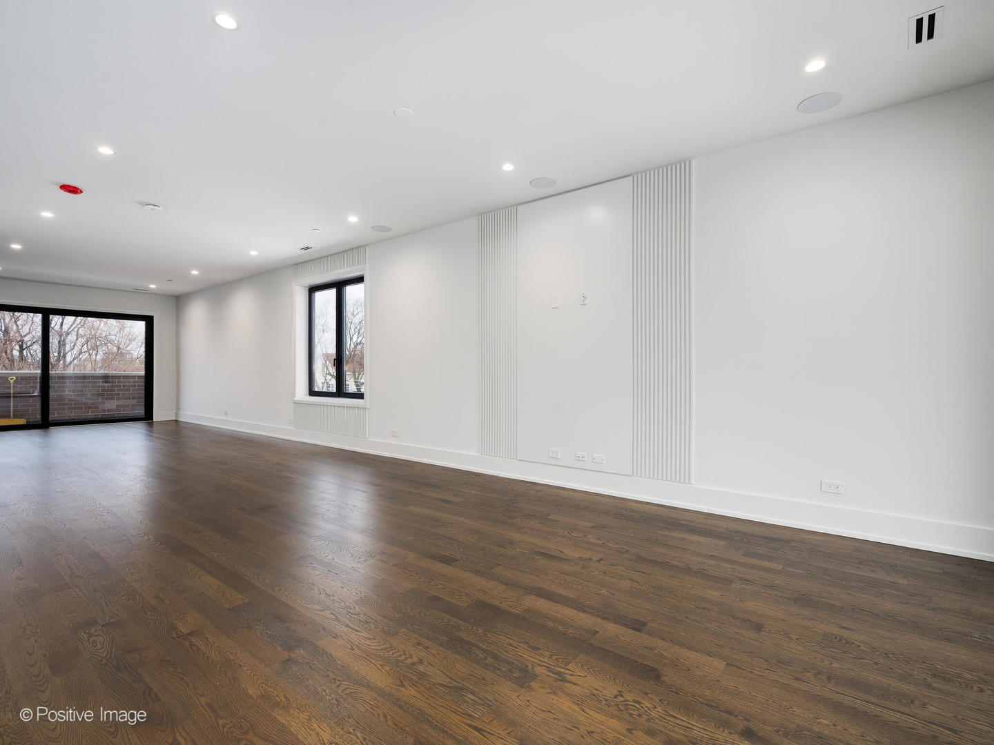 1216 West George Street Chicago, IL 60657 - Photo 24 of 42 a view of an empty room with wooden floor and a window