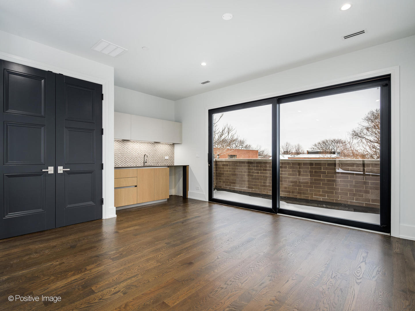 1216 West George Street Chicago, IL 60657 - Photo 26 of 42 a view of a room with wooden floor and large window