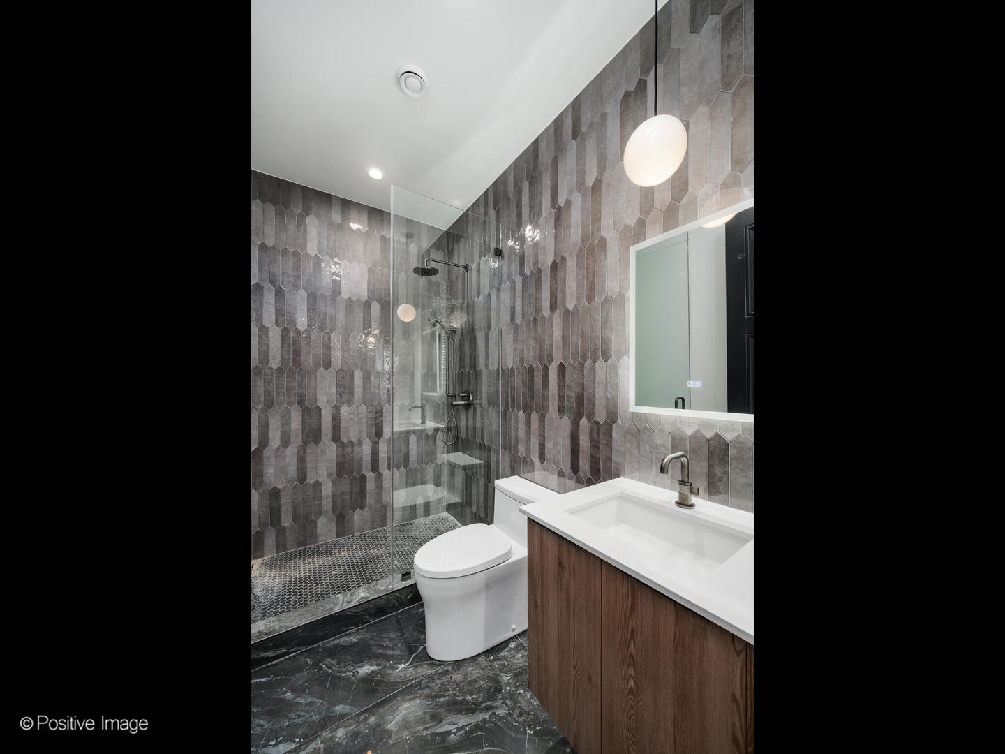 1216 West George Street Chicago, IL 60657 - Photo 28 of 42 a bathroom with a sink vanity granite toilet and a shower