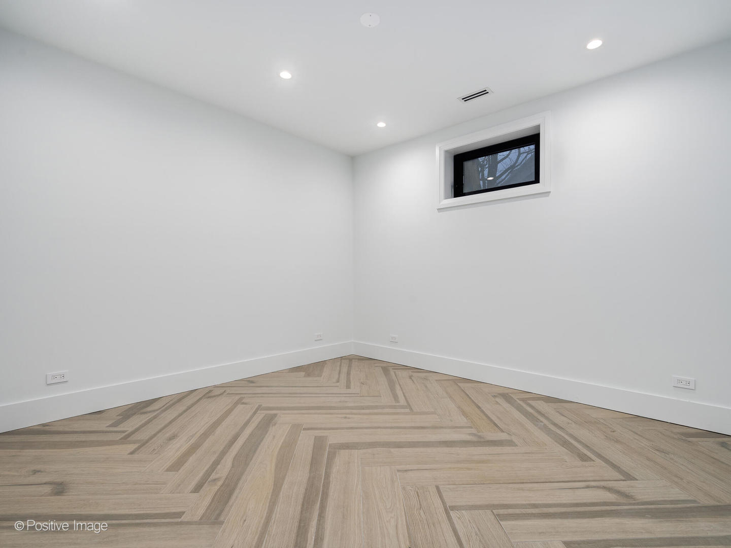 1216 West George Street Chicago, IL 60657 - Photo 31 of 42 a view of a room with wooden floor and white walls