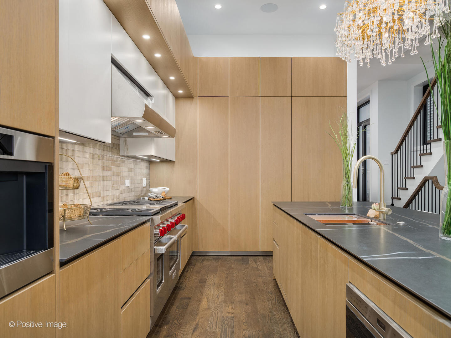 1216 West George Street Chicago, IL 60657 - Photo 9 of 42 a kitchen with stainless steel appliances granite countertop a sink and a stove