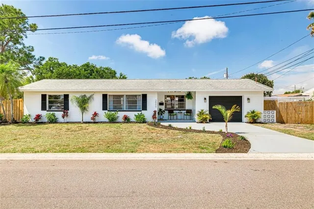a view of a house with backyard porch and sitting area