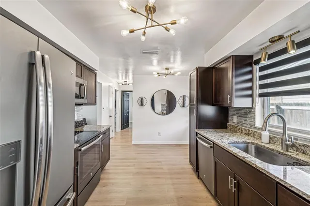 a kitchen with refrigerator cabinets and a sink