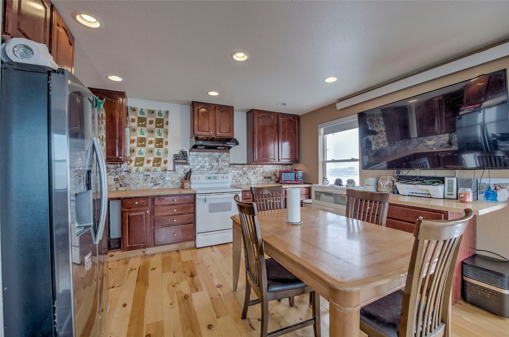 1620 Trout Road Fairplay, CO 80440 - Photo 2 of 31 Kitchen with backsplash, stainless steel appliances, and light wood-type flooring