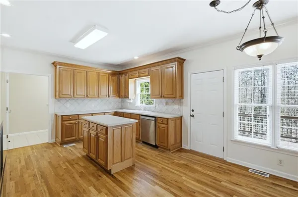 a kitchen with a stove and a wooden floors