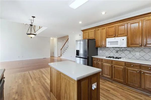 a kitchen with a stove a refrigerator and cabinets