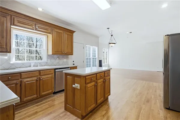 a kitchen with a sink stove and cabinets