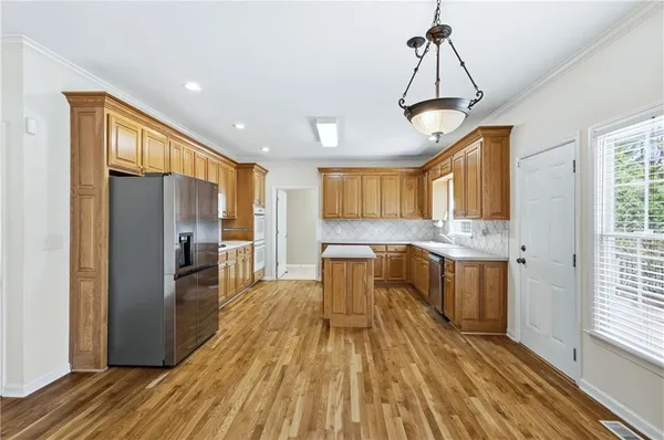 a very nice looking kitchen with a large window appliances and cabinets