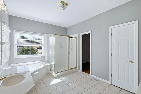 a view of an empty room with a sink and a window