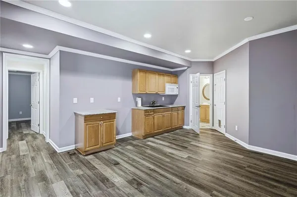 a view of a kitchen with a sink and a refrigerator