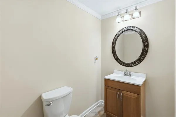 a bathroom with a sink mirror and toilet
