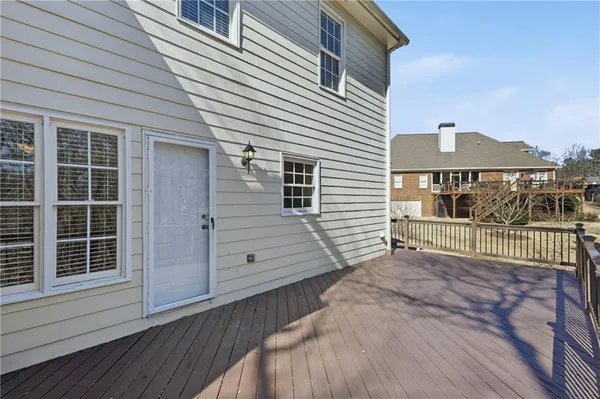 a view of a house with a wooden deck