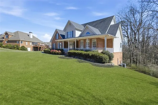 a front view of a house with a garden