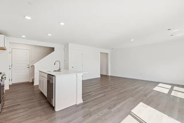 a view of a kitchen with a sink and a refrigerator