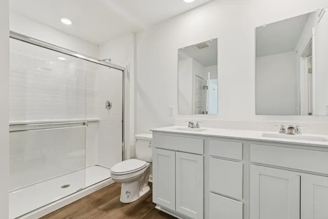 a bathroom with a toilet sink and shower