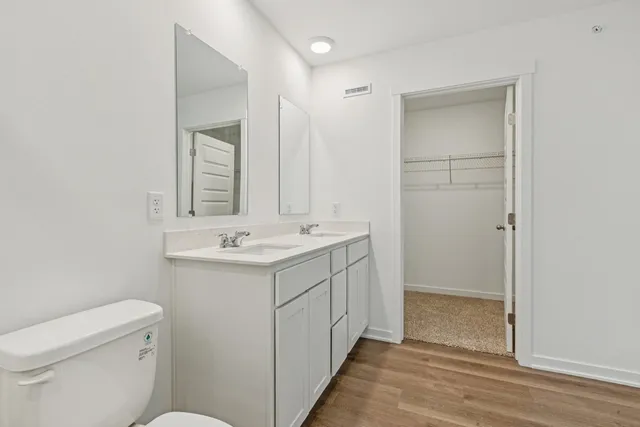 a bathroom with a sink toilet and mirror