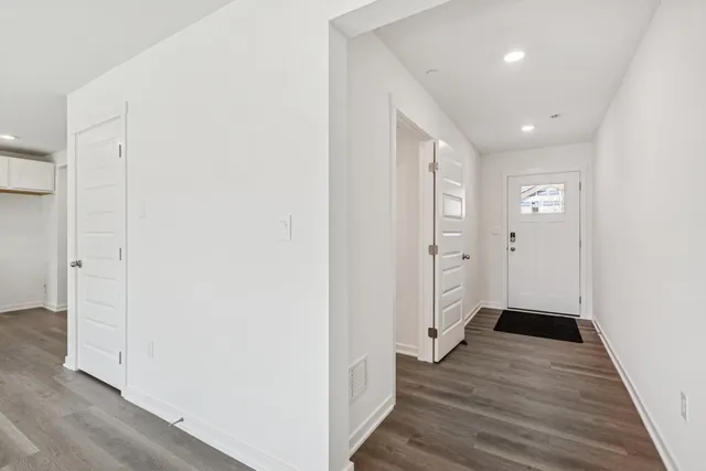 a view of a hallway with wooden floor