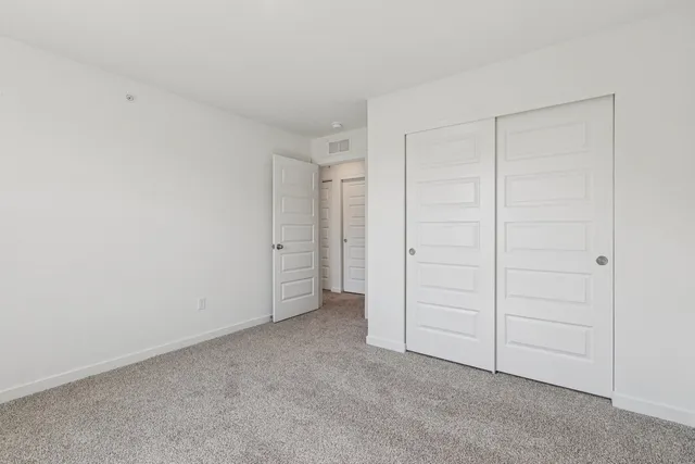 an empty room with closet area
