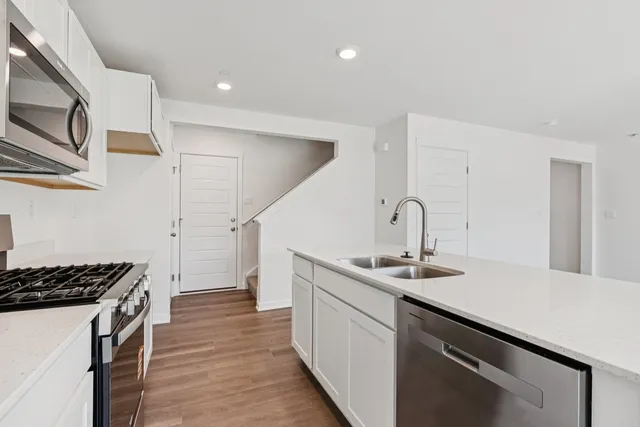 a kitchen that has a sink and a stove in it
