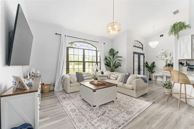 a dining room with furniture and wooden floor