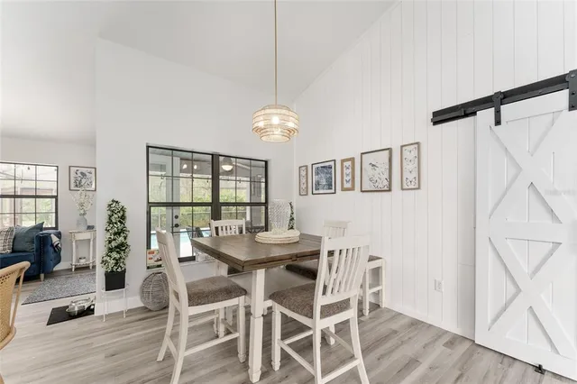 a large kitchen with a lot of counter space and wooden floor