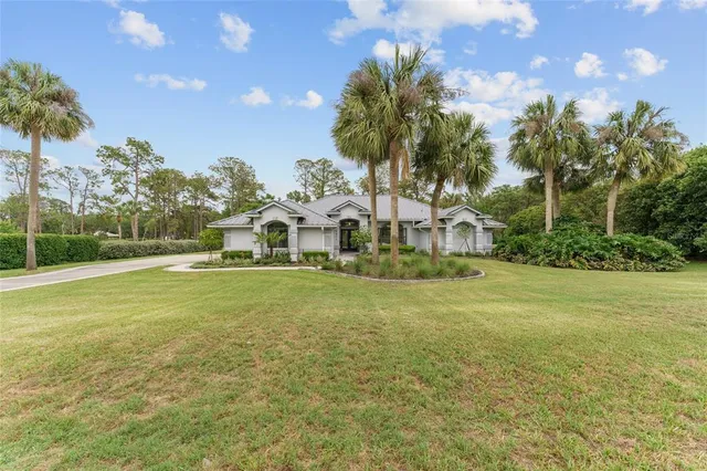 a view of a house with a yard and entertaining space
