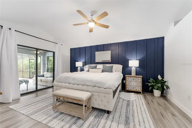 a view of a dining room with furniture large windows and wooden floor