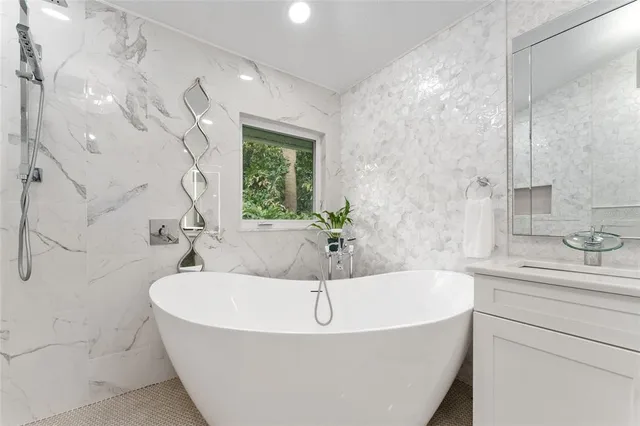 a view of a patio with table and chairs under an umbrella with large trees