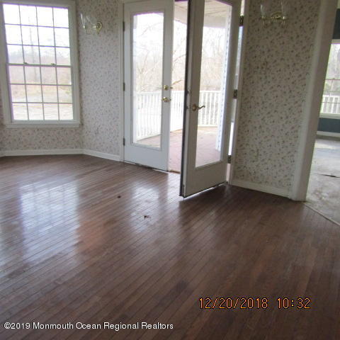 35 Holmes Mill Road Cream Ridge, NJ 08514 - Photo 3 of 7 an empty room with wooden floor and windows