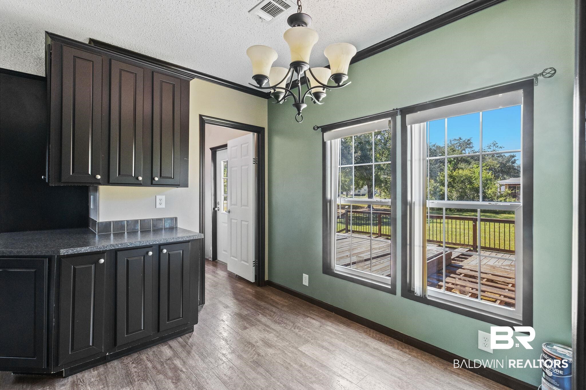 6870 Cecilia Court Theodore, AL 36582 - Photo 27 of 83 Kitchen with an inviting chandelier, a textured ceiling, light wood-type flooring, and crown molding