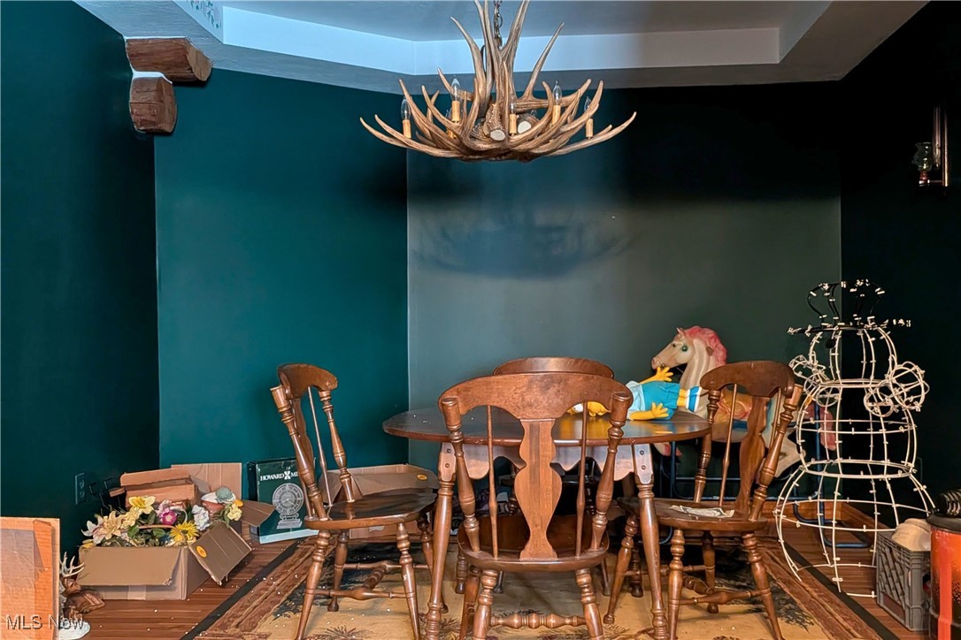 8026 Lee Road Northwest Malvern, OH 44644 - Photo 9 of 44 Dining area with a chandelier and a tray ceiling