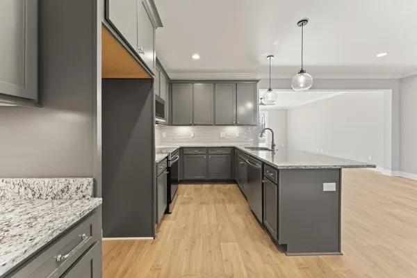 a kitchen with kitchen island a counter top space a sink stainless steel appliances and cabinets